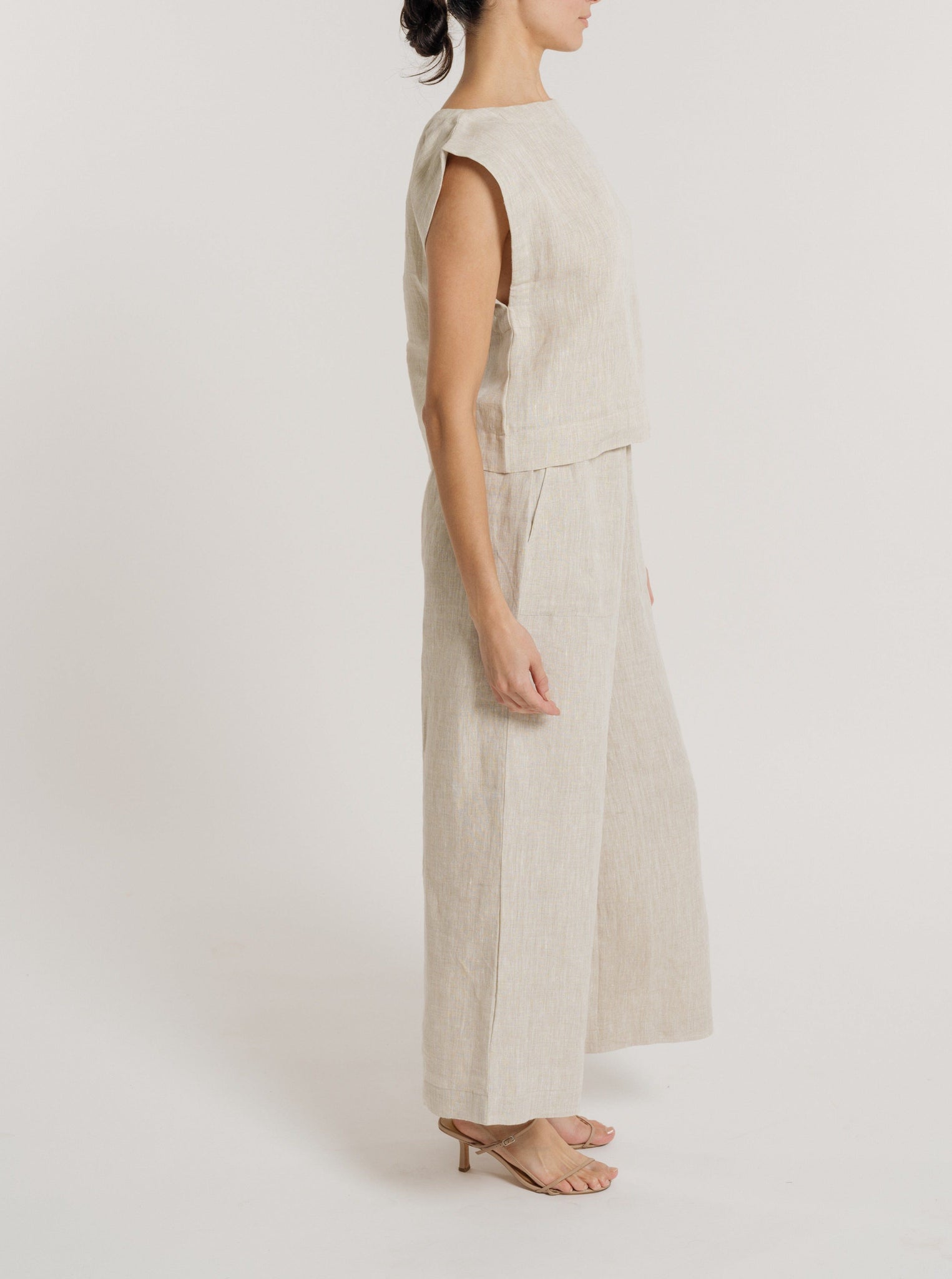 The model is wearing an Everyday Top - Natural Linen jumpsuit.