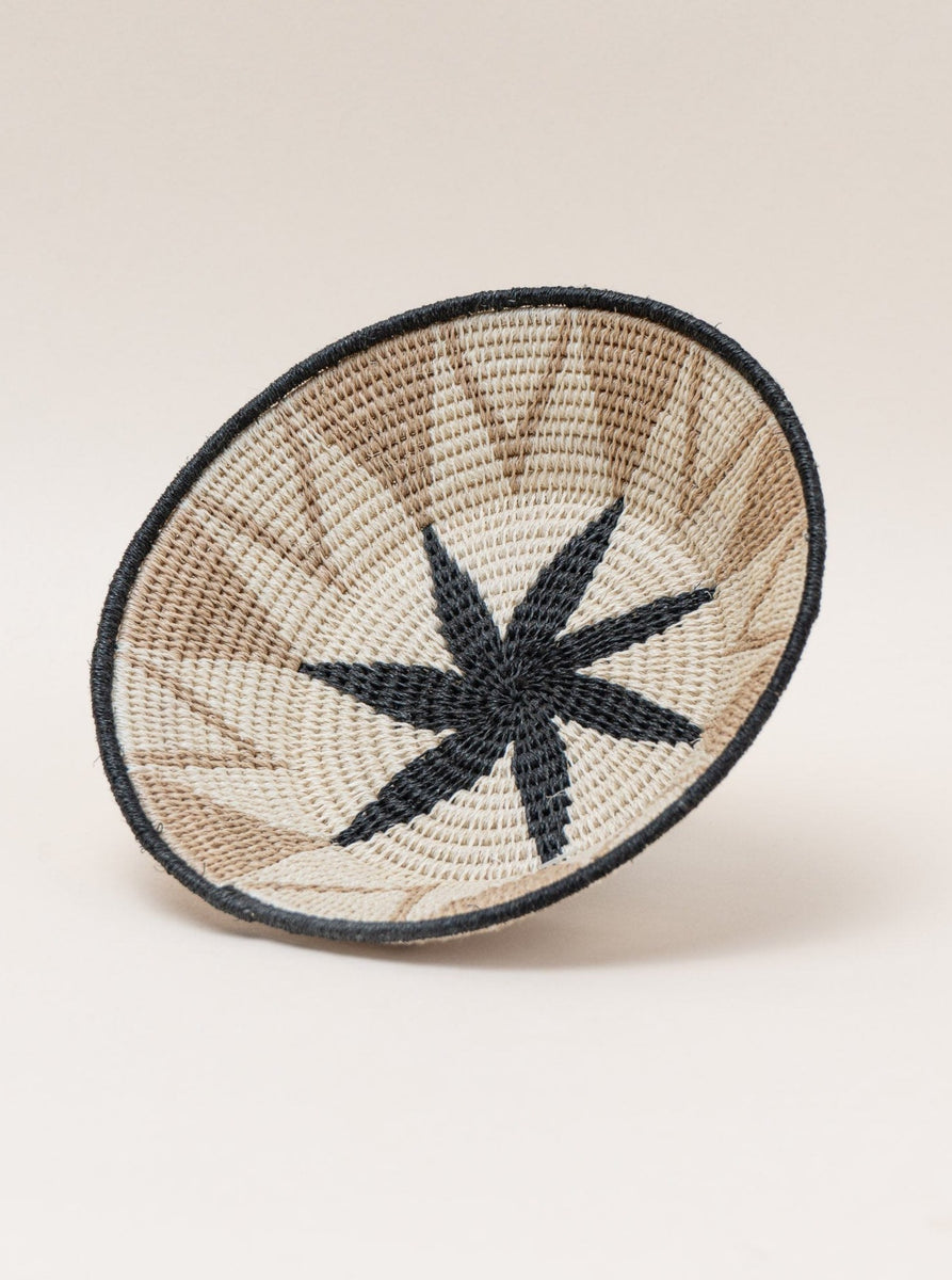A Handmade Sisal Catchall Basket with a star design, showcasing Swazi weaving techniques.
