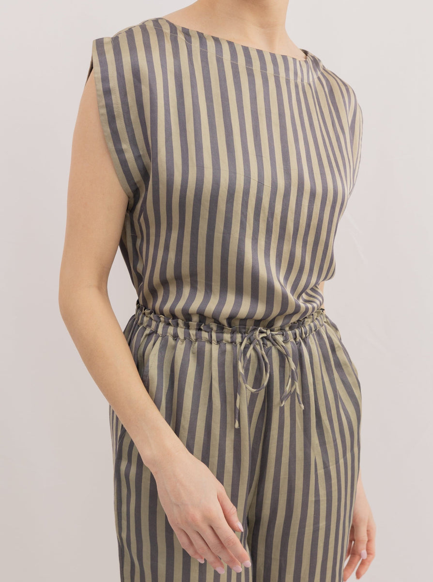 Woman wearing an Everyday Top - Urban Stripe with statement shoulders and matching drawstring pants.