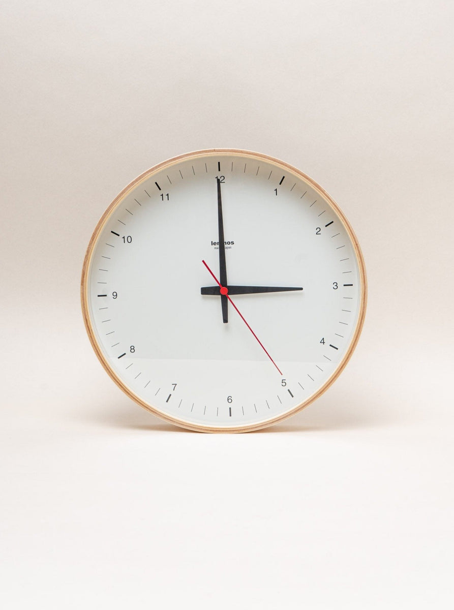 A high-quality Lemnos Plywood Clock handmade in Japan, featuring a red face on a white background.