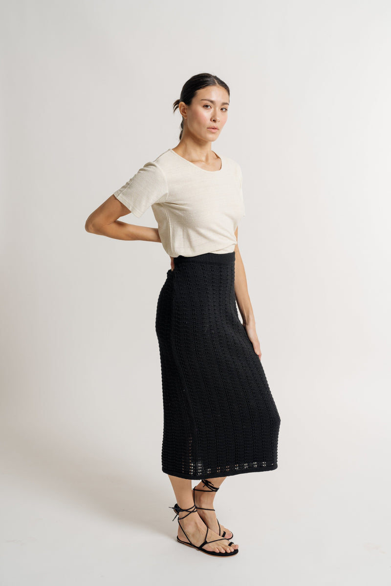 A model wearing a Straight Knit Skirt - Black with an elasticated waistband.