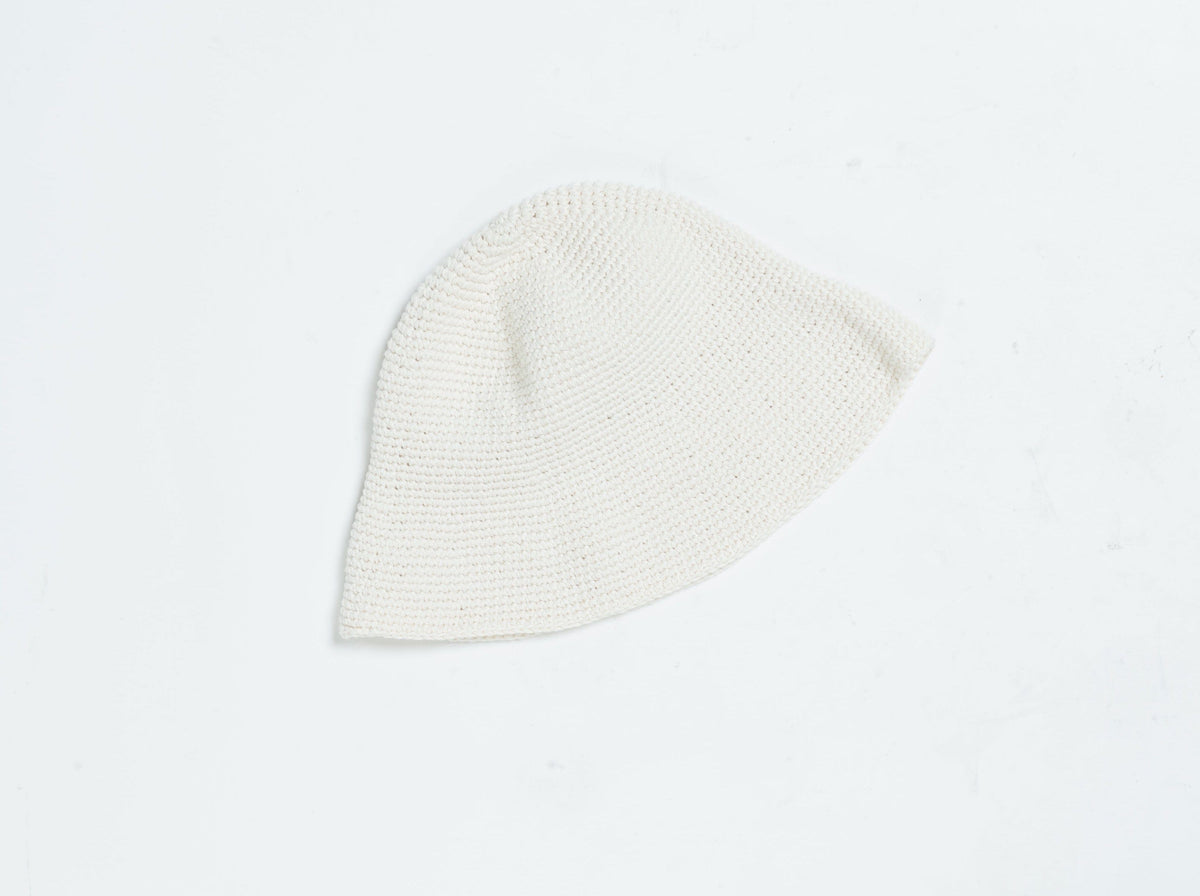 A vintage-inspired Crochet Bell Hat - Ivory on a white surface.